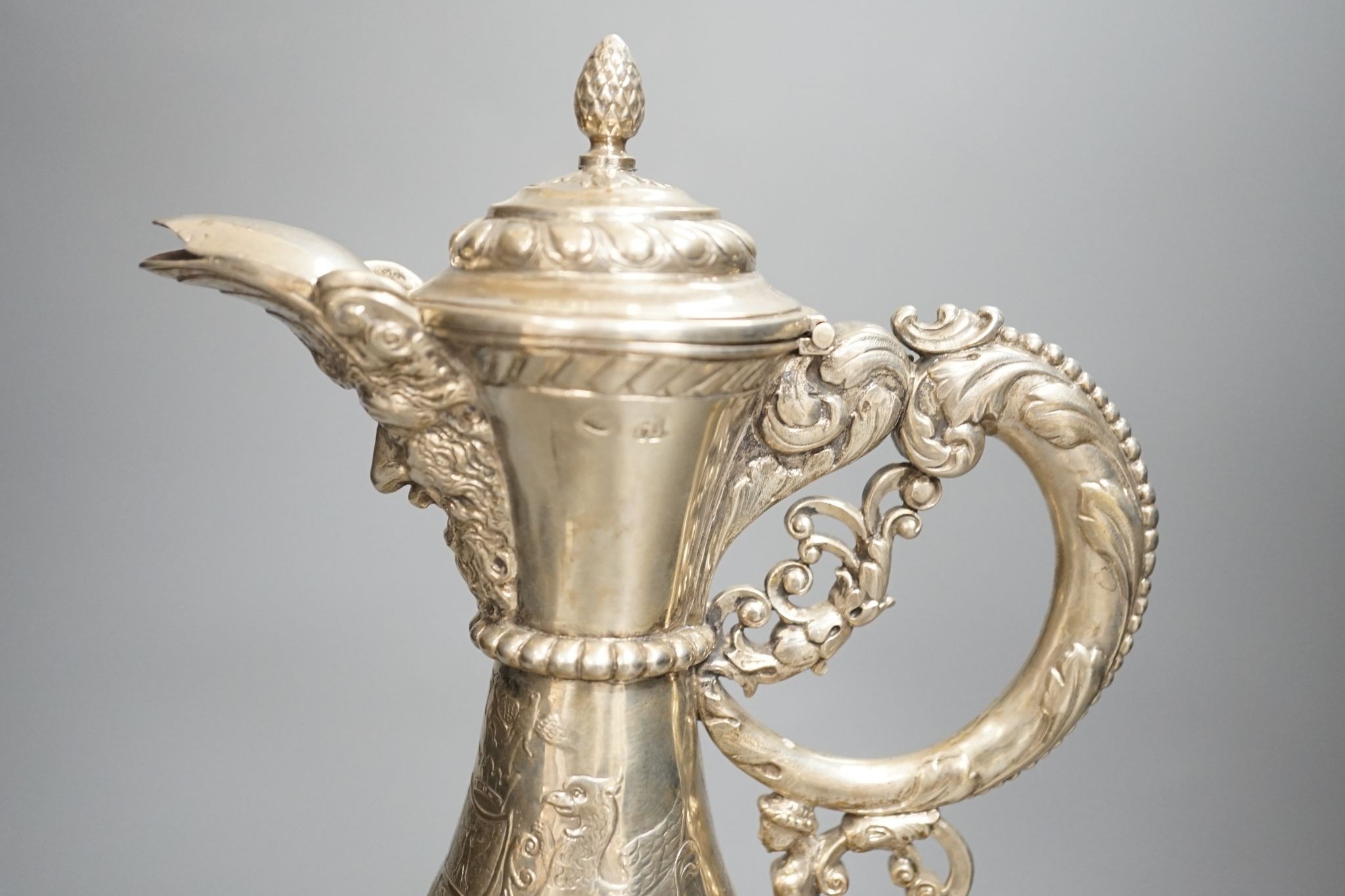 A 19th century Continental white metal wine ewer, embossed with swags and masks, height 29.9cm, 16.5oz.